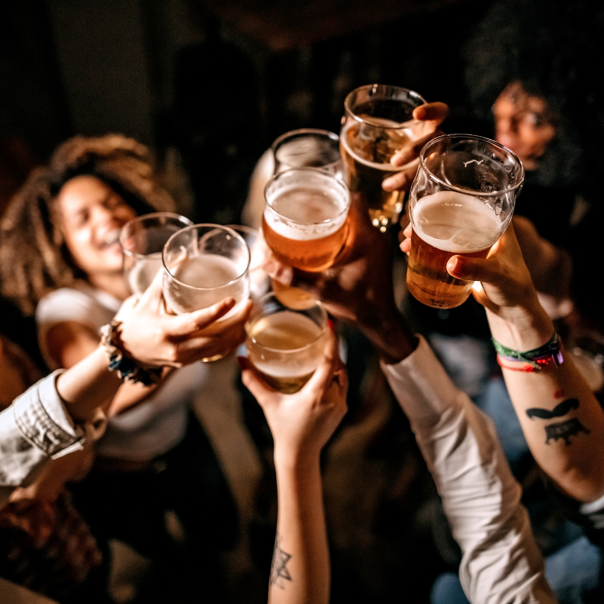 A group of individuals raising beer glasses.