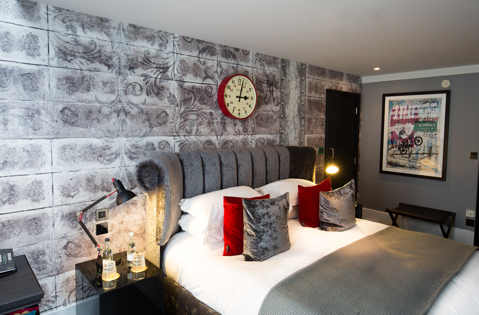 Bedroom featuring a comfortable bed and a wall-mounted clock.
