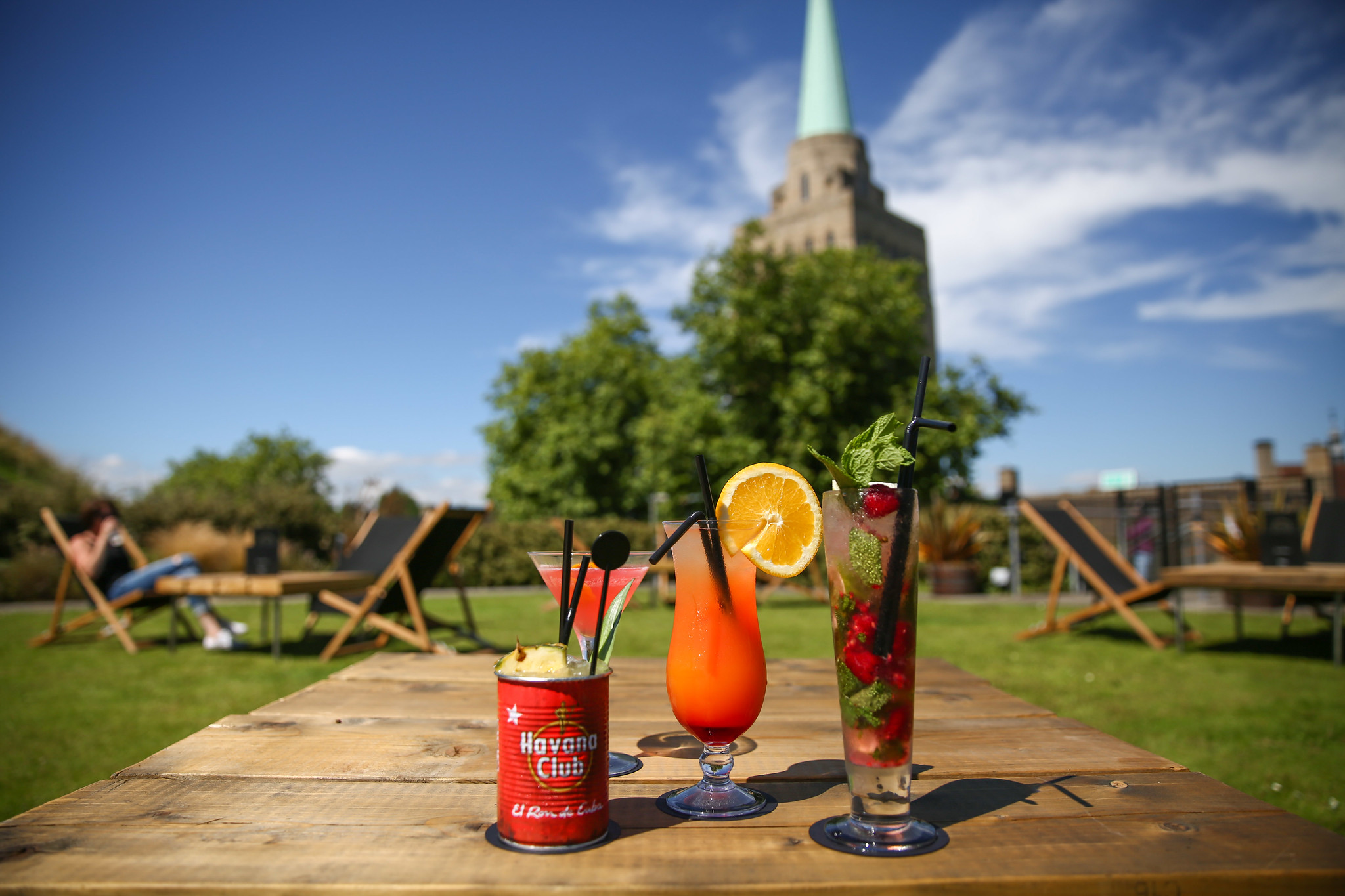 Two glasses filled with drinks placed on a wooden table.