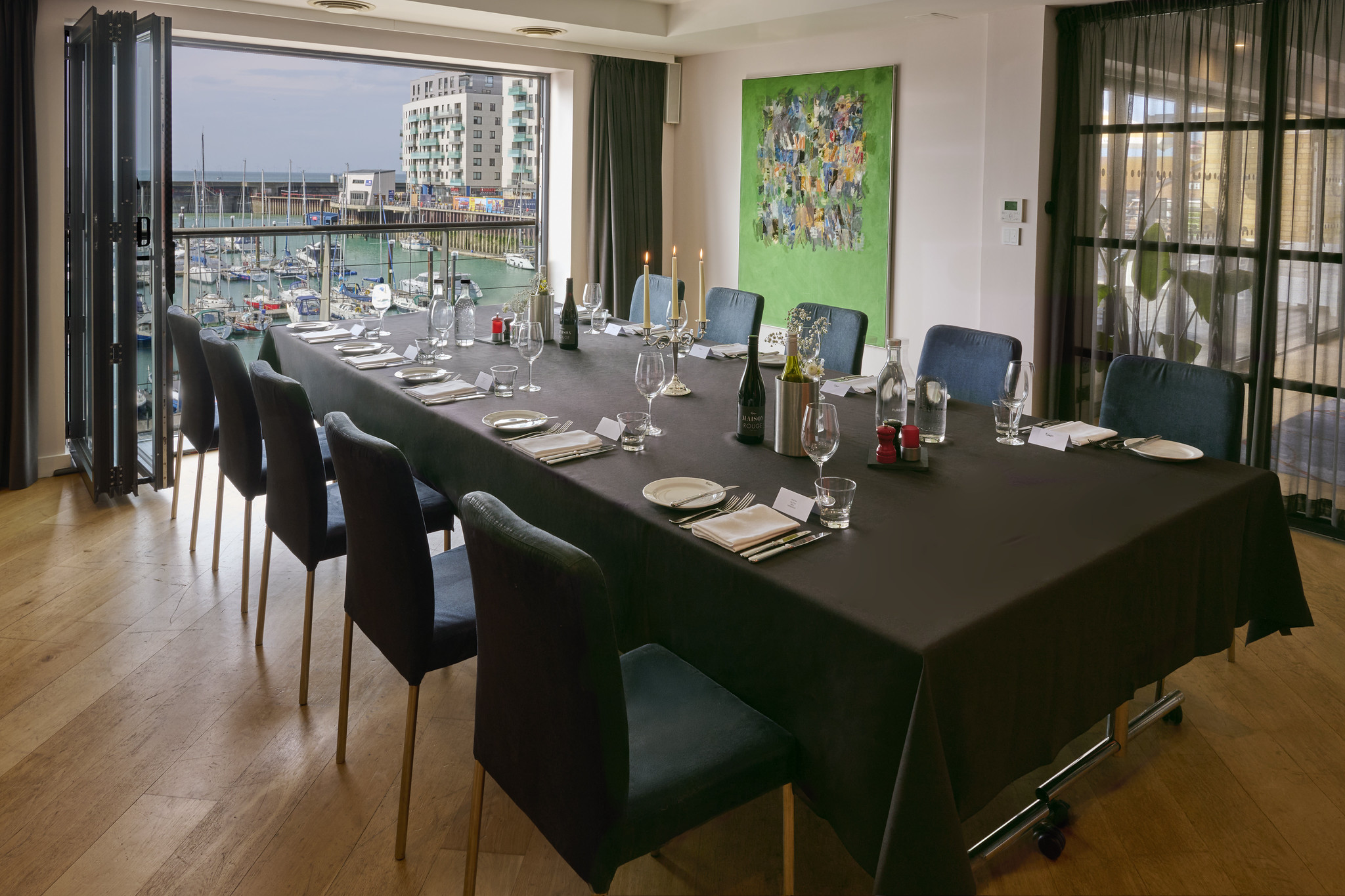 Dining room featuring a table and chairs with round glass ceiling lighting fixtures and a feature window 