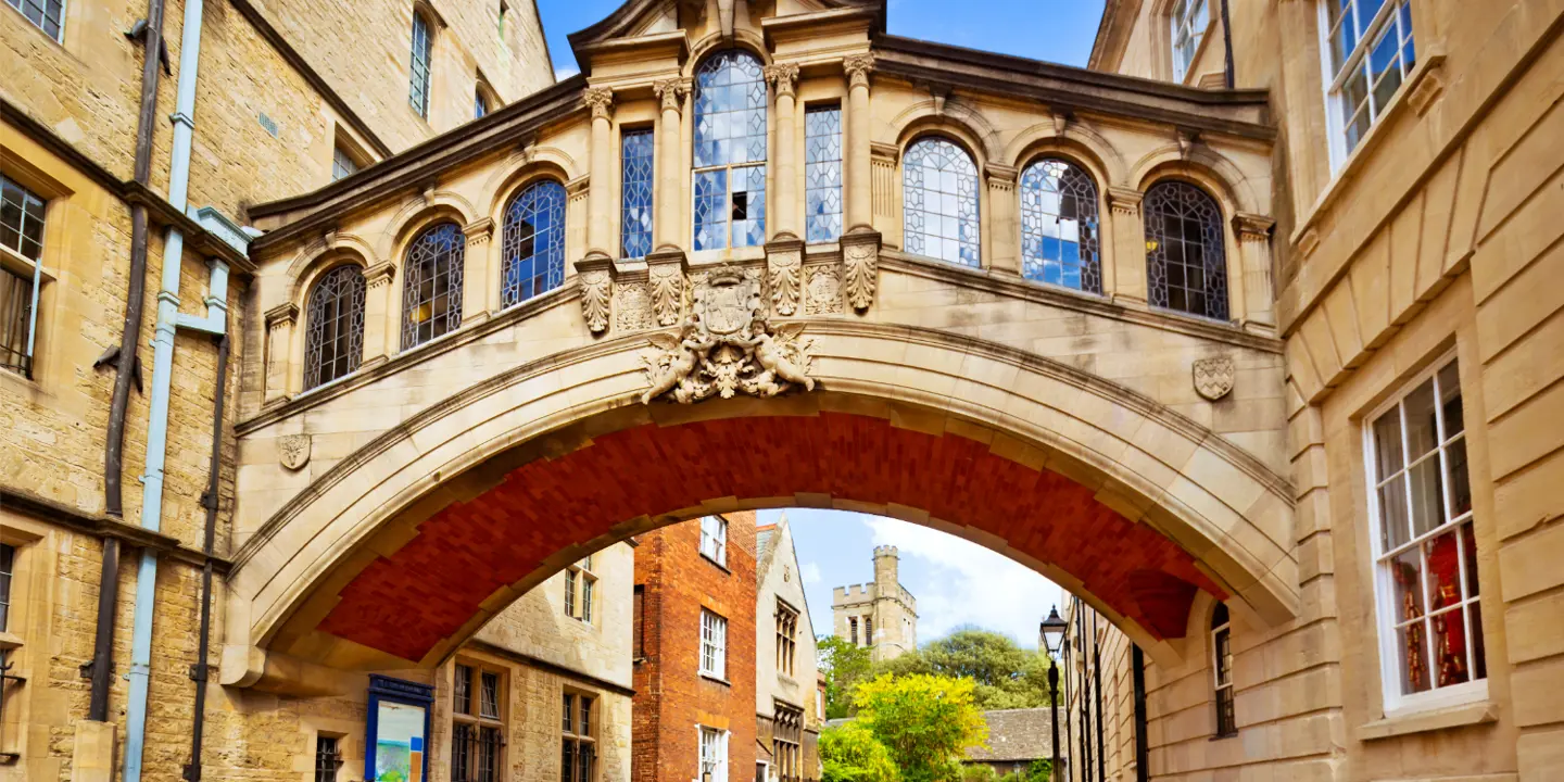 City street with a bridge overhead.