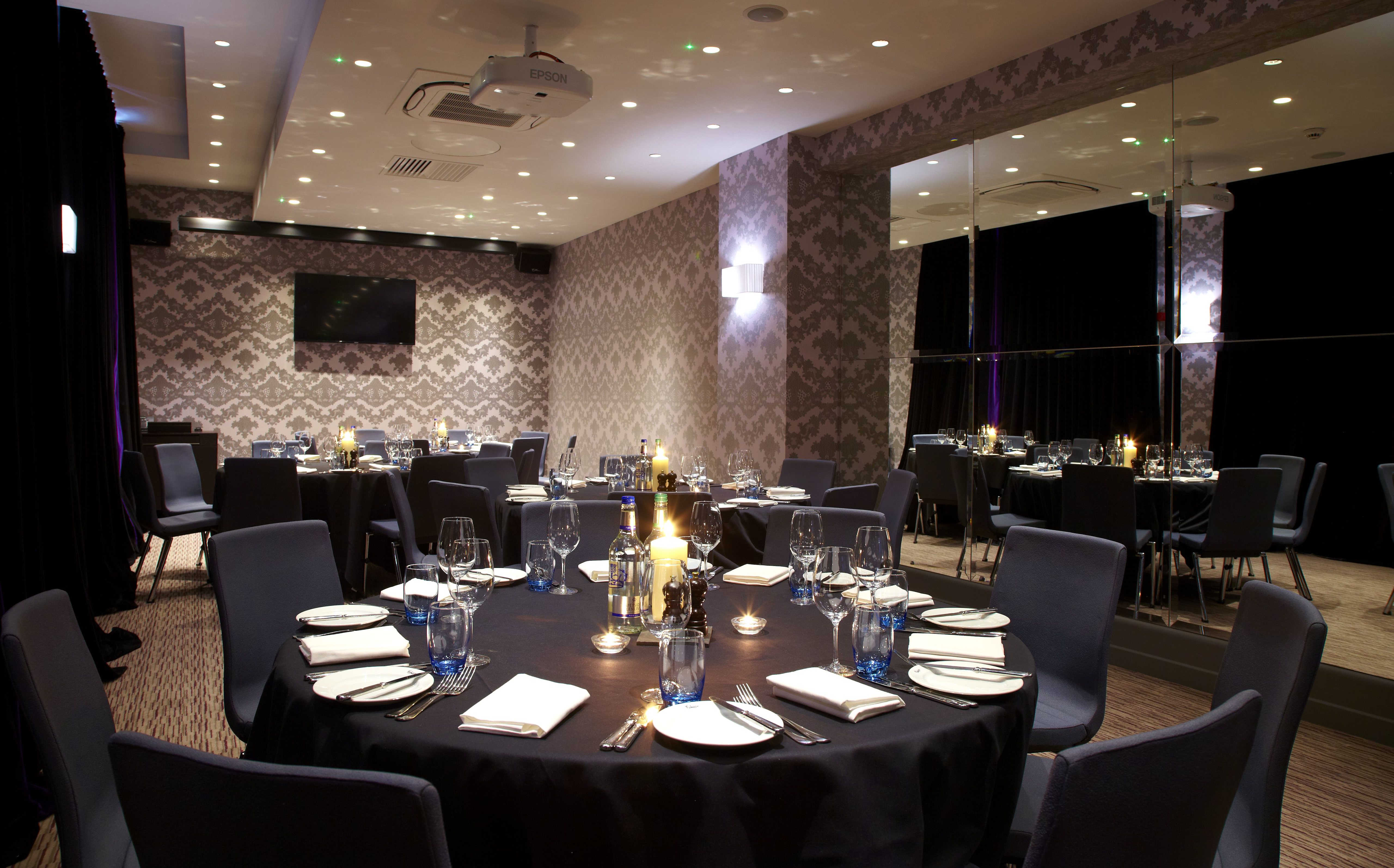 A beautifully arranged table for a formal dinner, adorned with elegant candles.