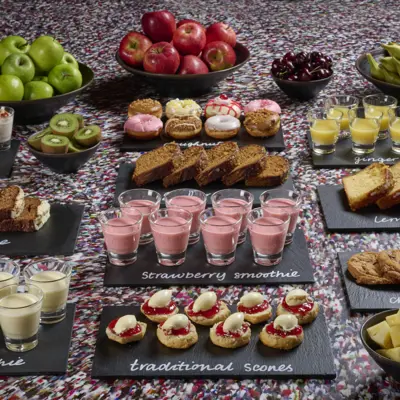 Tray of food displayed on a table in front of a captivating mural.