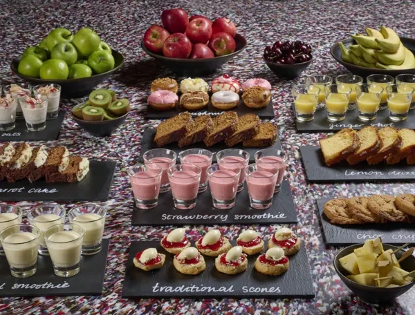 Tray of food displayed on a table in front of a captivating mural.