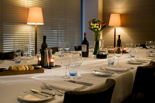 Private dining table for guests, with wine and glasses available