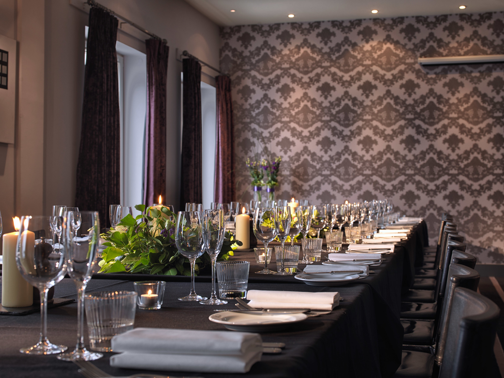 A beautifully arranged table adorned with elegant place settings and flickering candles.