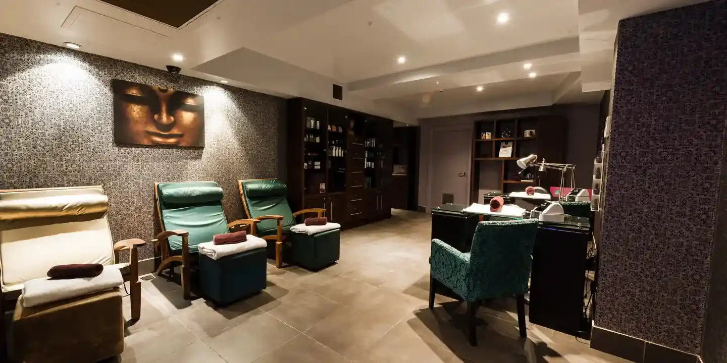 A well-furnished spa room with an elegant painting adorning the wall.