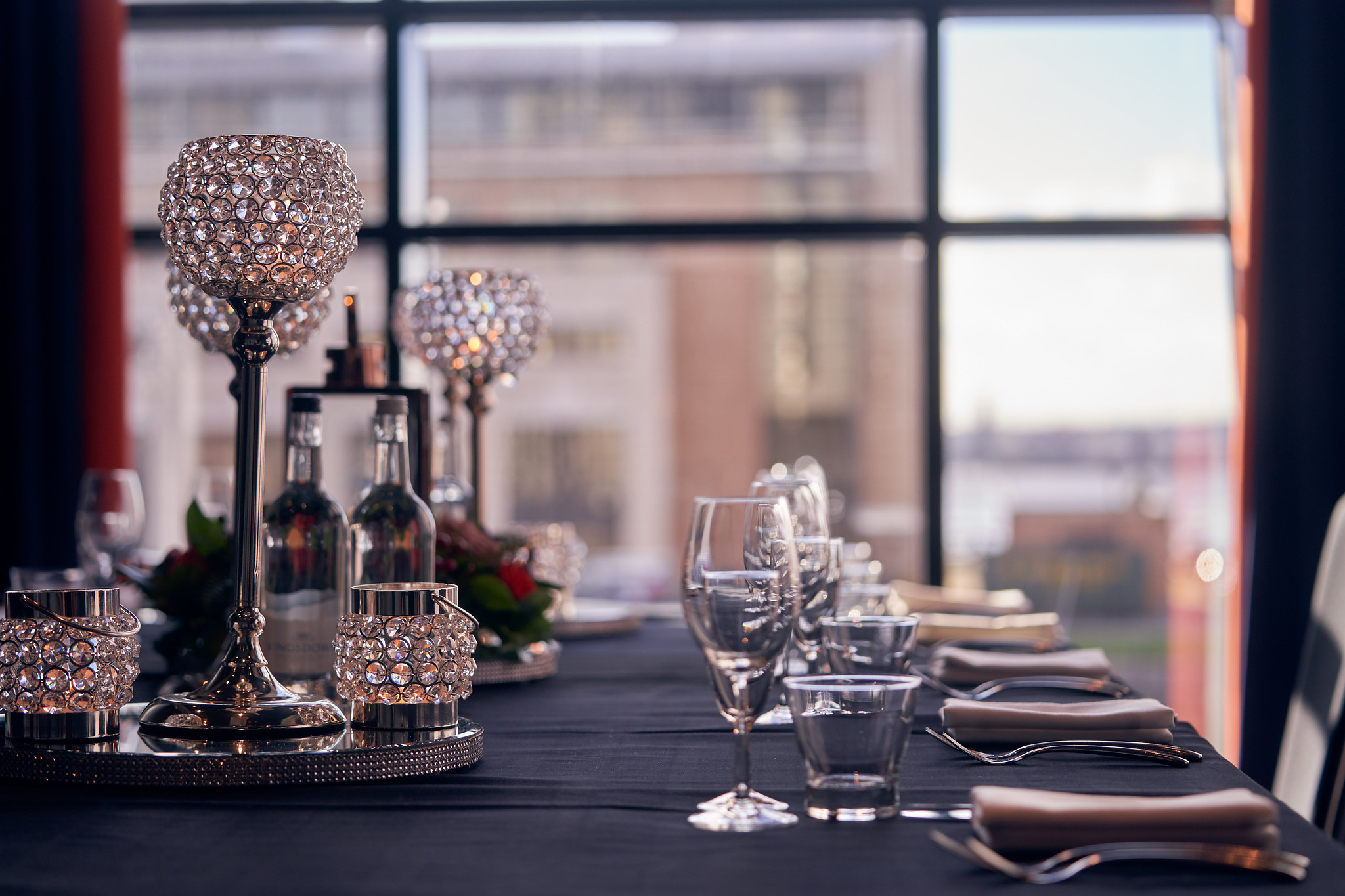 A beautifully arranged table adorned with elegant wine glasses and gleaming silverware.
